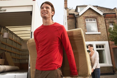Local movers handling furniture near a Liverpool property entrance