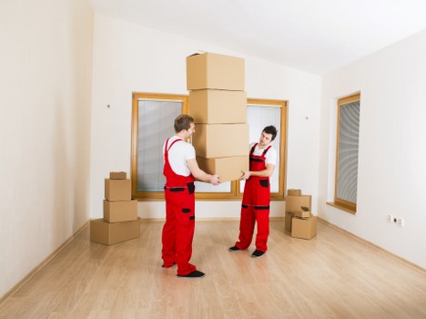 Removal team carrying boxes in a Liverpool residential street